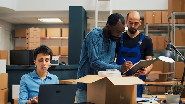 entrepreneurs-team-preparing-shipment-order-with-products-from-warehouse-racks-working-delivery-logistics-with-laptop-diverse-people-planning-business-development-supply-chain_482257-59661.jpg